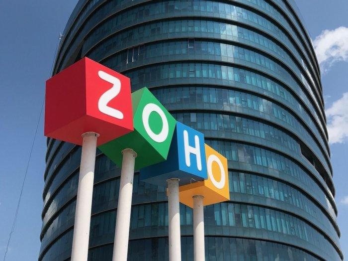 Zohoâ€™s logo next to a high building.